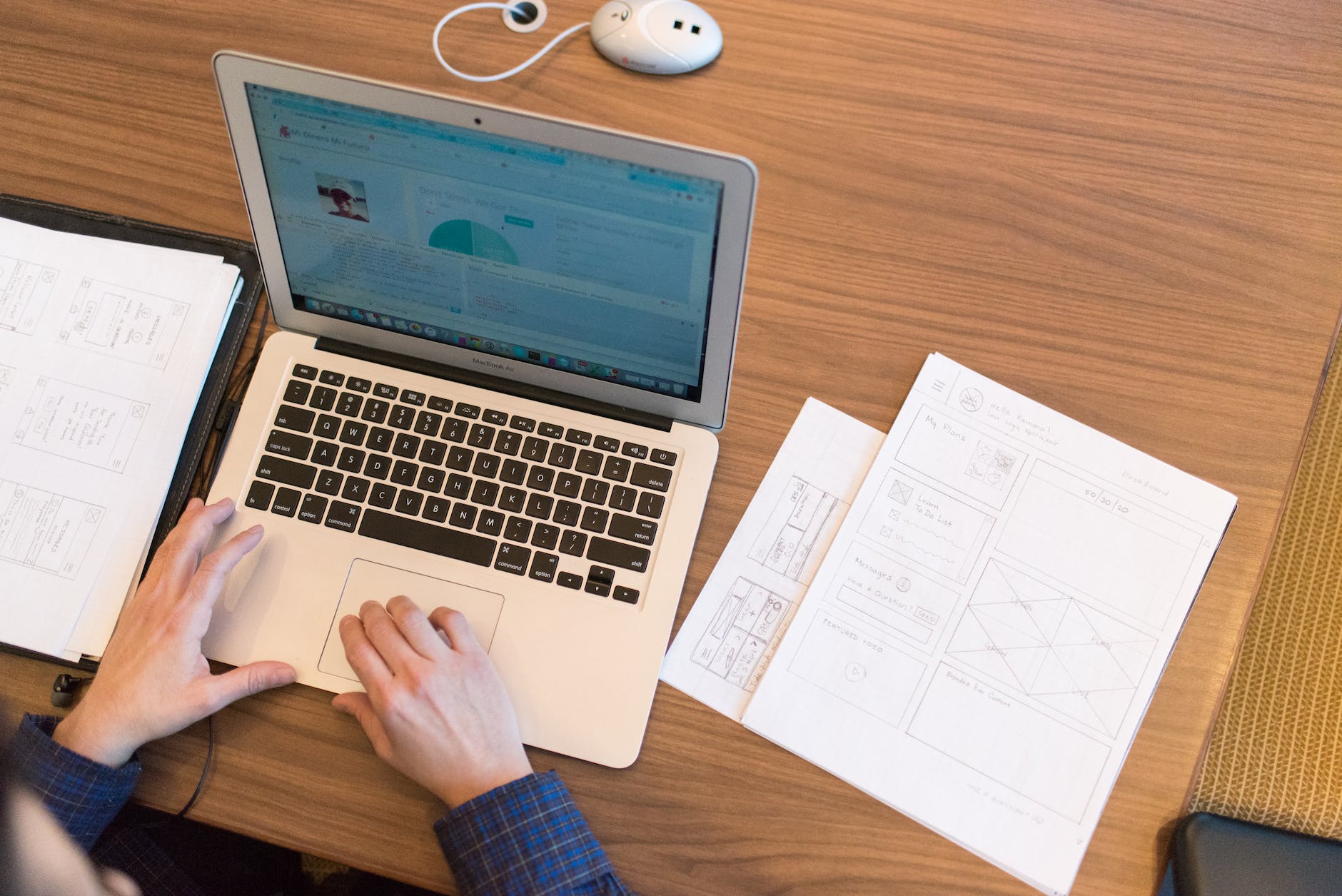 person s hands on top of macbook air